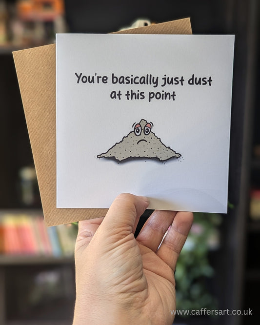 Greeting card with the phrase "You're basically just dust at this point" and sad cartoon dust pile illustration